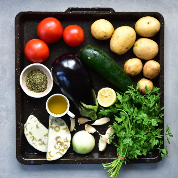 all the vegetables needed to prepare briami on a black tray