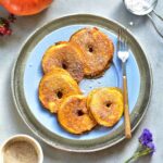 Pumpkin apple ring pancakes on a blue plate.