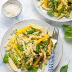 Pasta primavera on a blue plate.