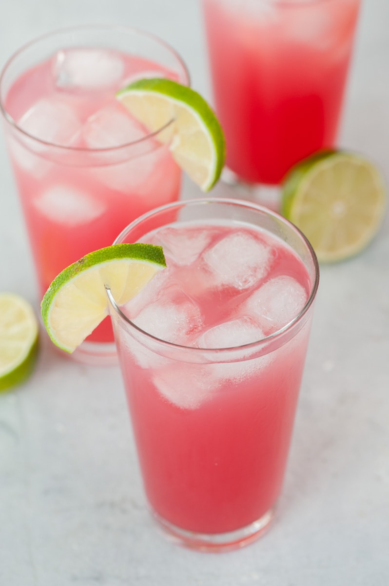 Sea breeze cocktail in a tall glass garnished with a lime slice.