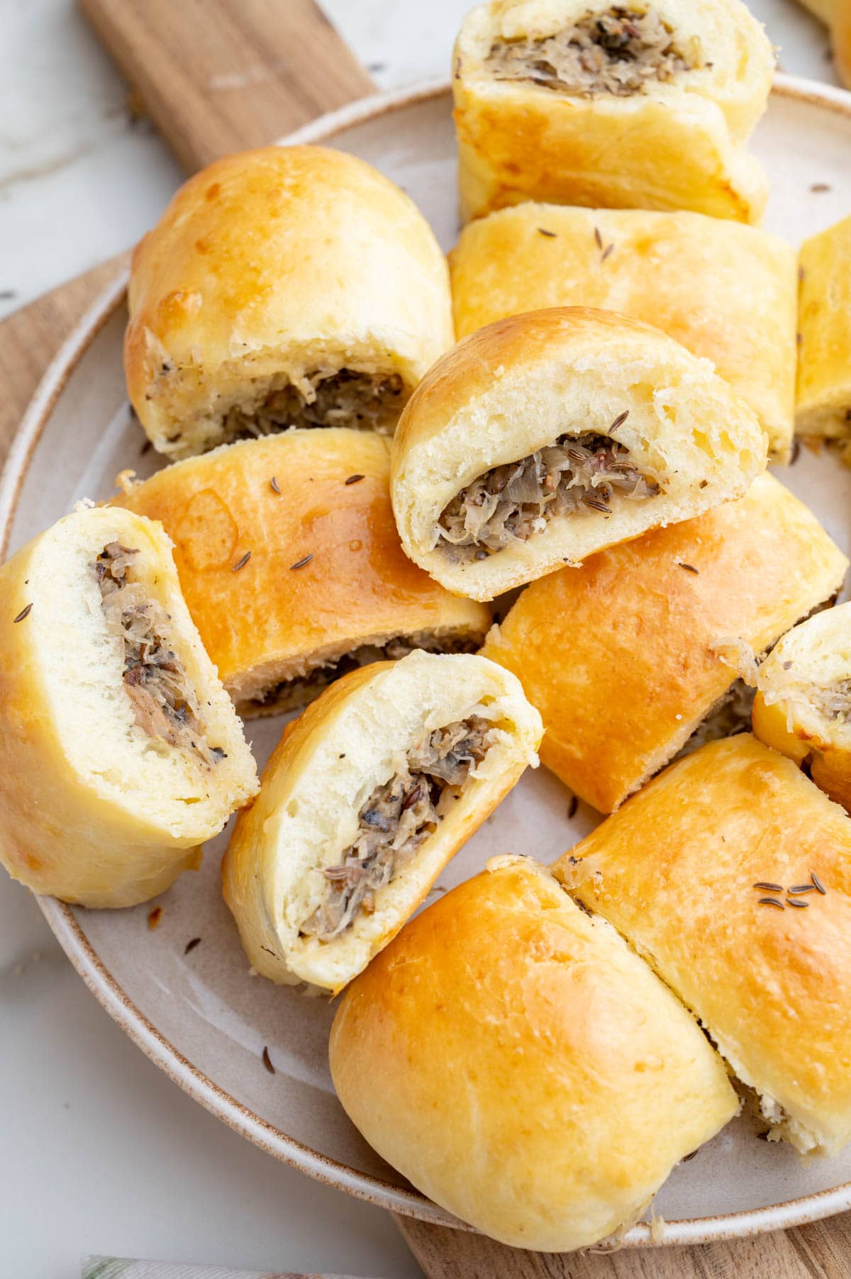 Sauerkraut and mushrooms buns on a plate.
